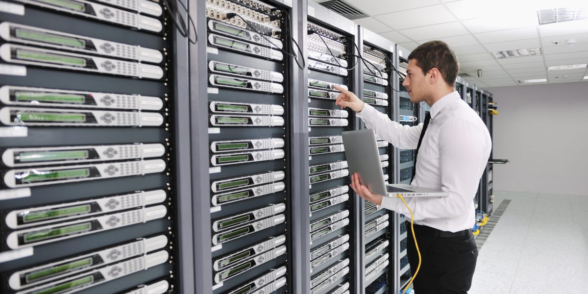 young engeneer in datacenter server room